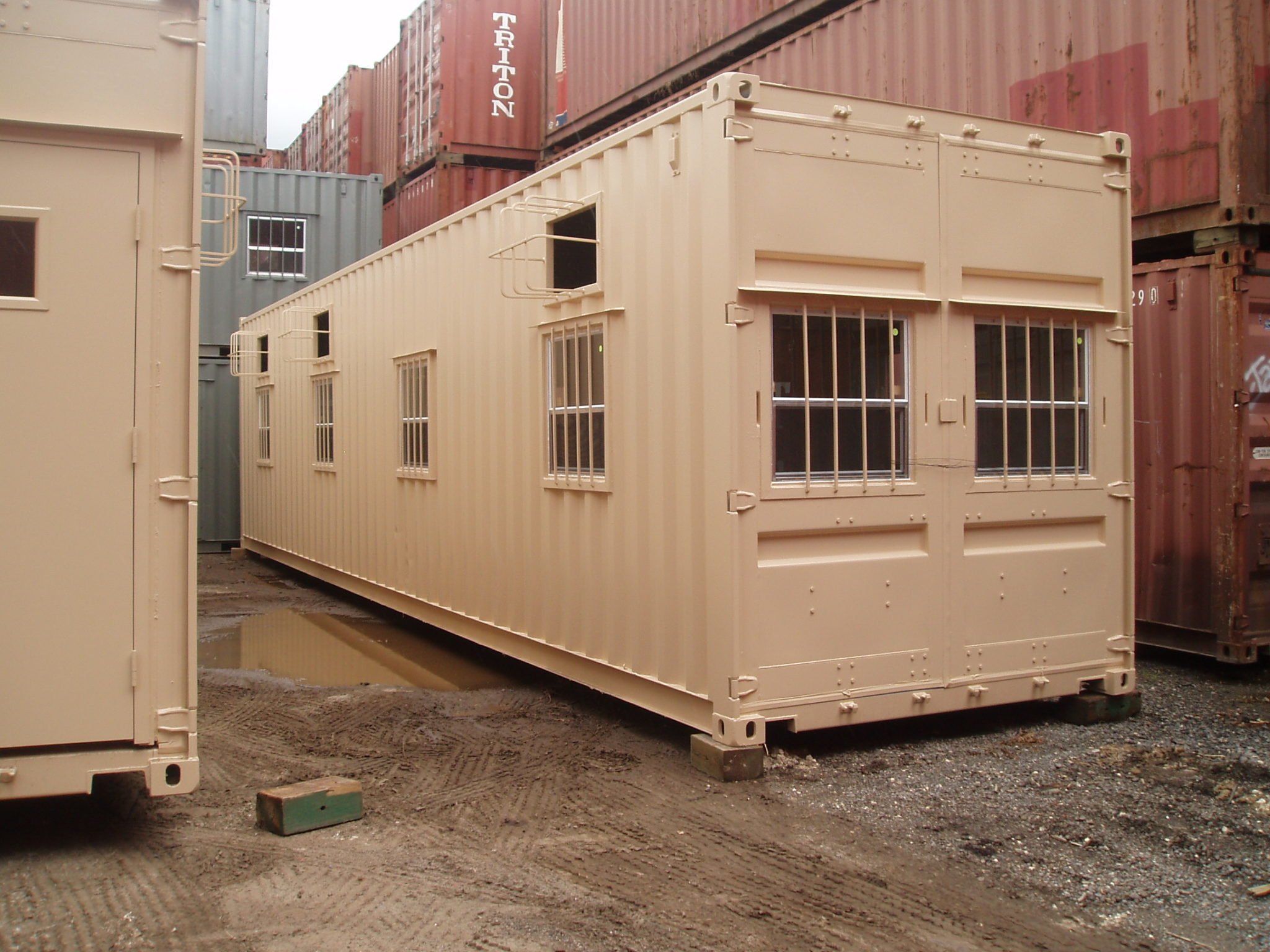 A American Container's buildout with multiple barred windows and A/Cs