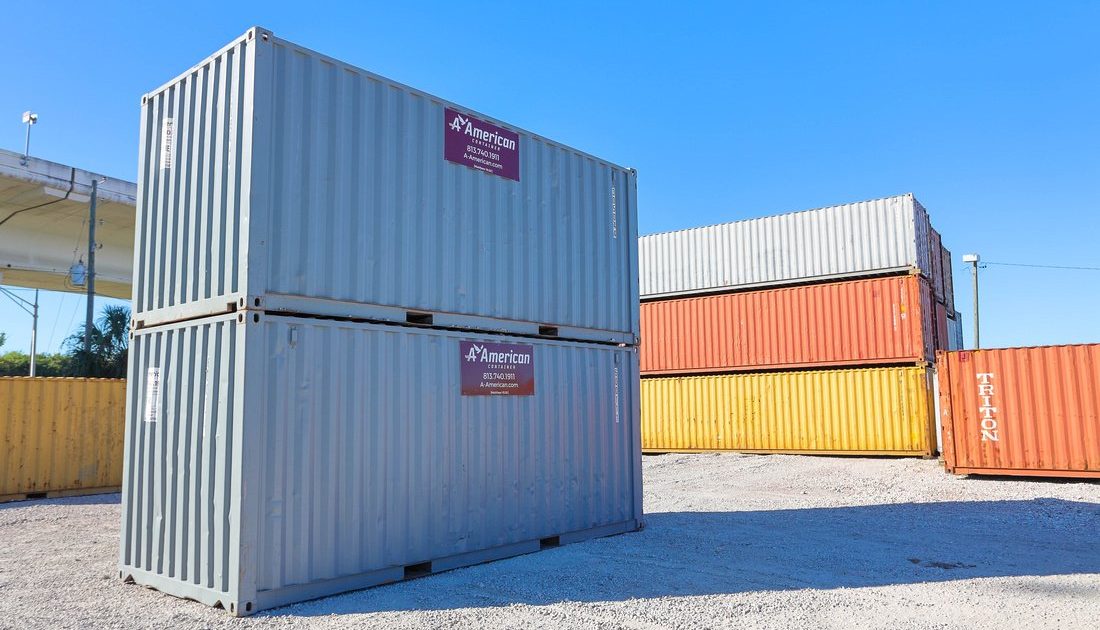 Gray 20-foot shipping containers stacked on A American Container lot