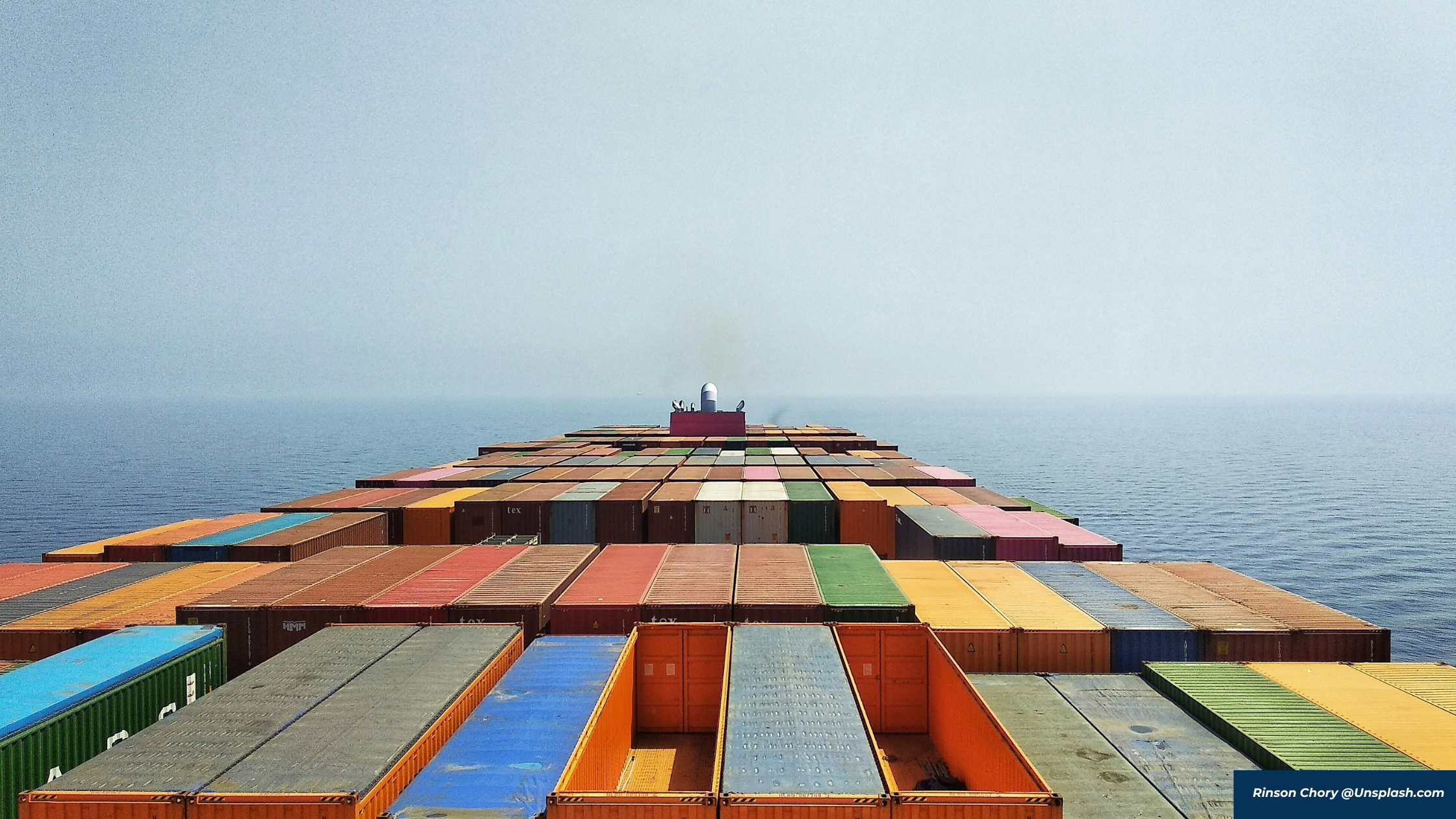 container ship at sea with container stacks