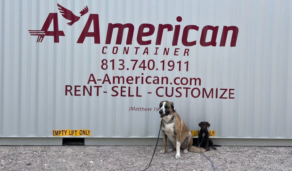 dogs in front of container with logo 
