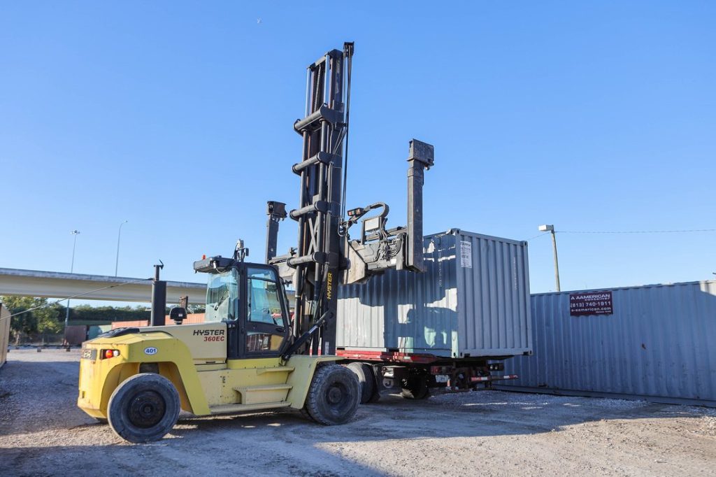 gray 20-foot container on lift at A American lot 