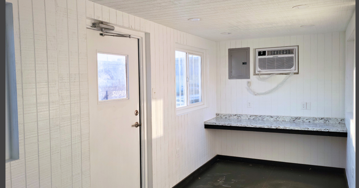 interior of container office with desk and HVAC unit