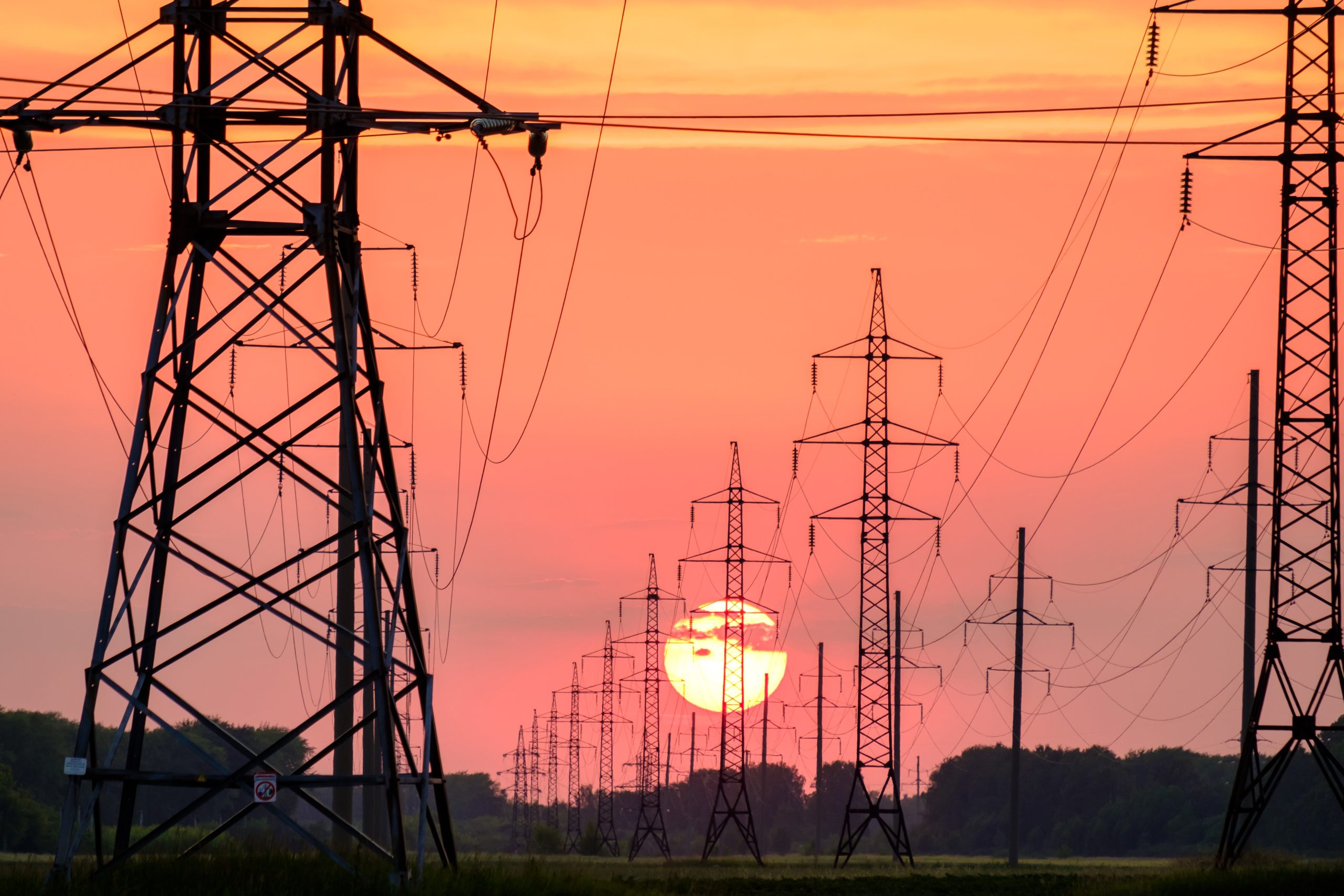 power lines with sun setting in back