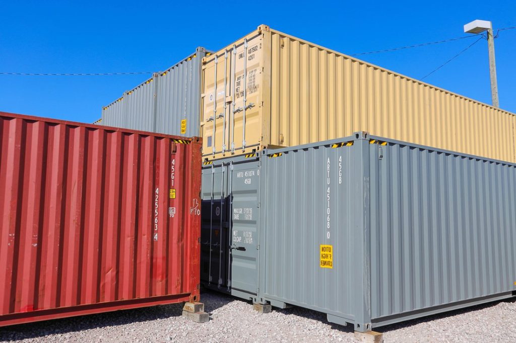 Stacks of colorful shipping containers at A American Container Lot