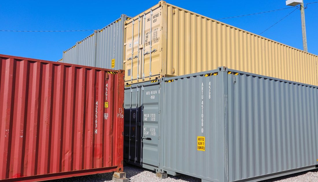 Stacks of colorful shipping containers at A American Container Lot